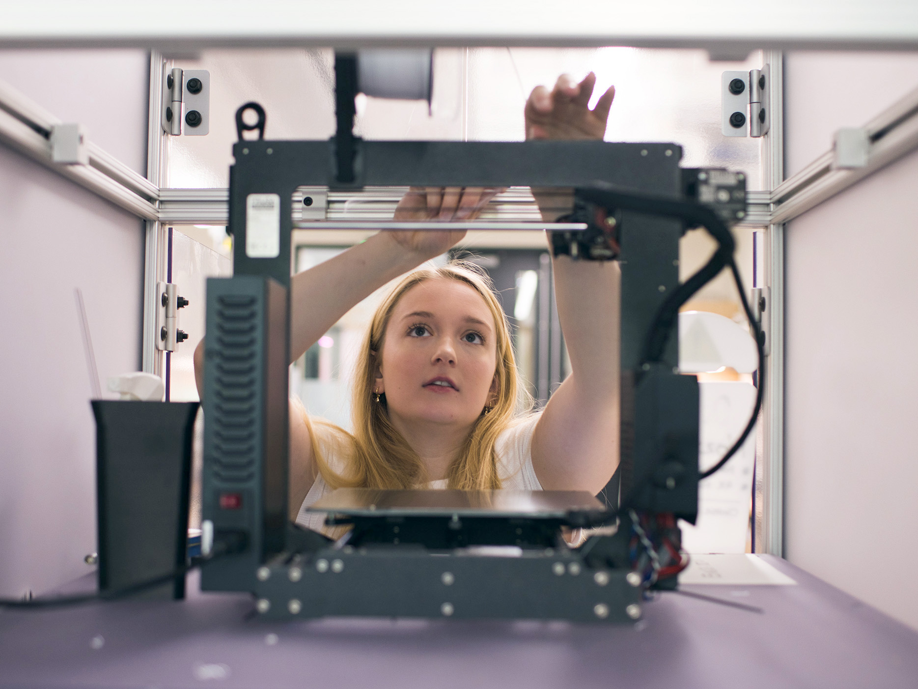 a woman adjusts equipment in a lab