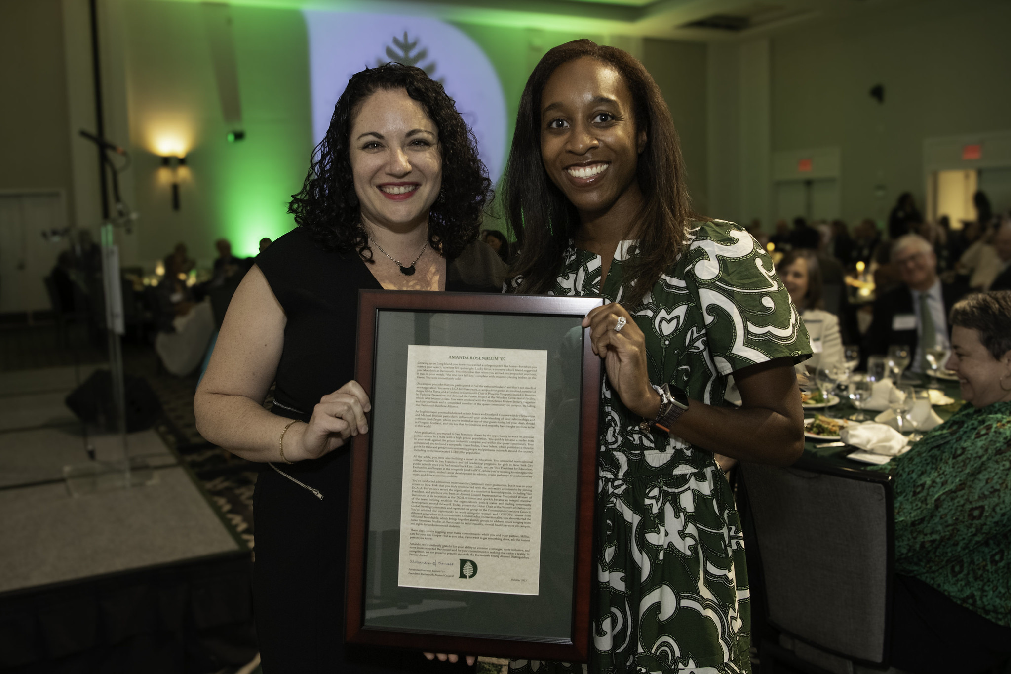 Alumni council president Alex Barnett holding an award with Amanda Rosenblum