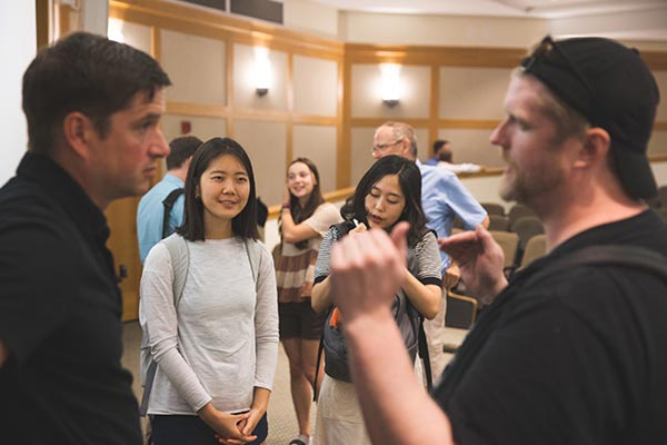 A group of people talking to each other