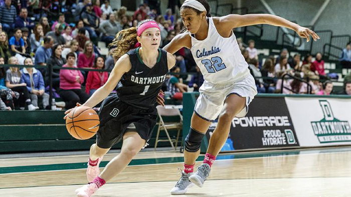 Dartmouth basketball player drives to the basket around an opposing player