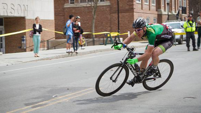 A cyclist leans to the left as he starts a turn during a road race