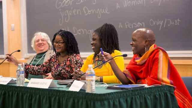 Four people sit at a table answering questions in a panel discussion on diversity, equity, and inclusion