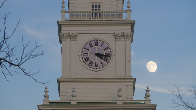 Baker Tower clock with moon in the background