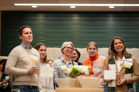 A row of adults smiling and listening