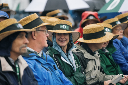 50th reunion attendees in straw hats sitting at commencement. 