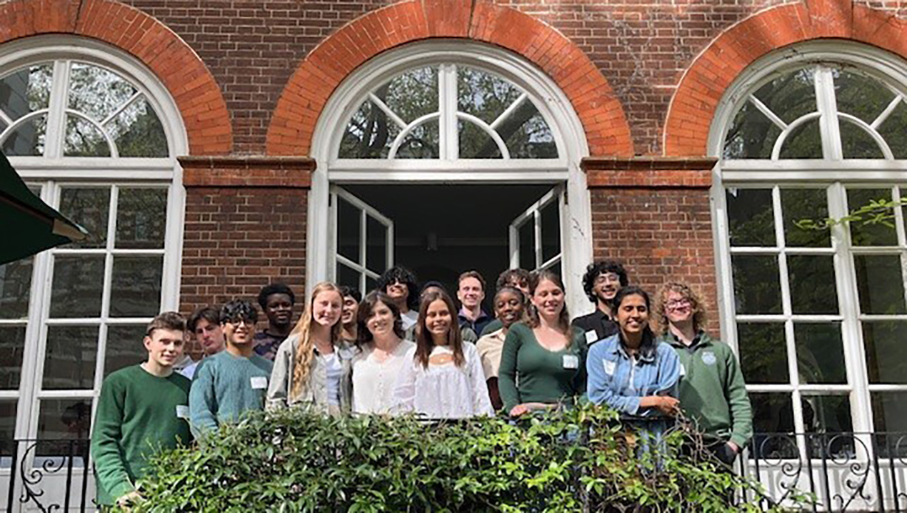 A group of prospective Dartmouth students posing for a photo at an admitted students event in London. 