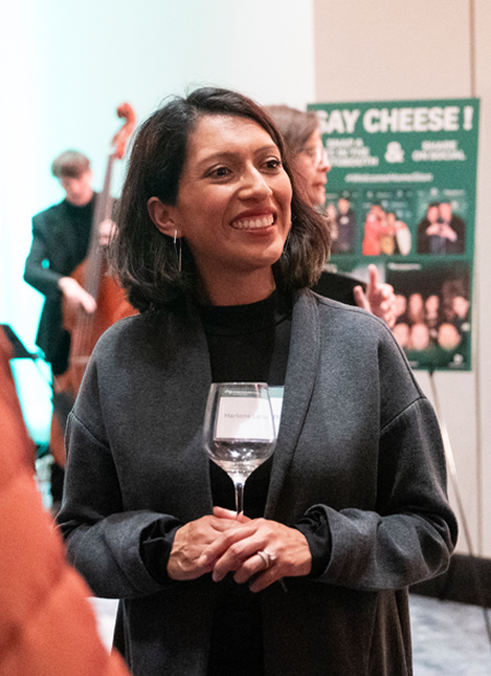 Woman smiling and enjoying a drink at PWT event