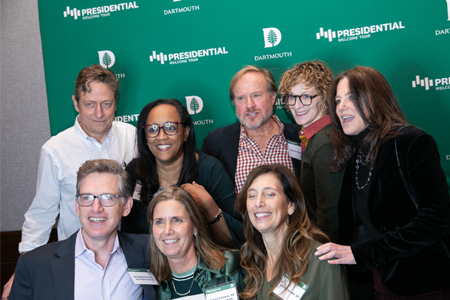 A group of alumni smiling in a photobooth