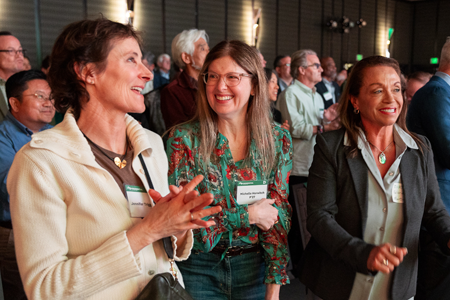 Three women smiling and laughing