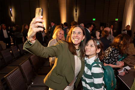 President Beilock taking a selfie with a young alum