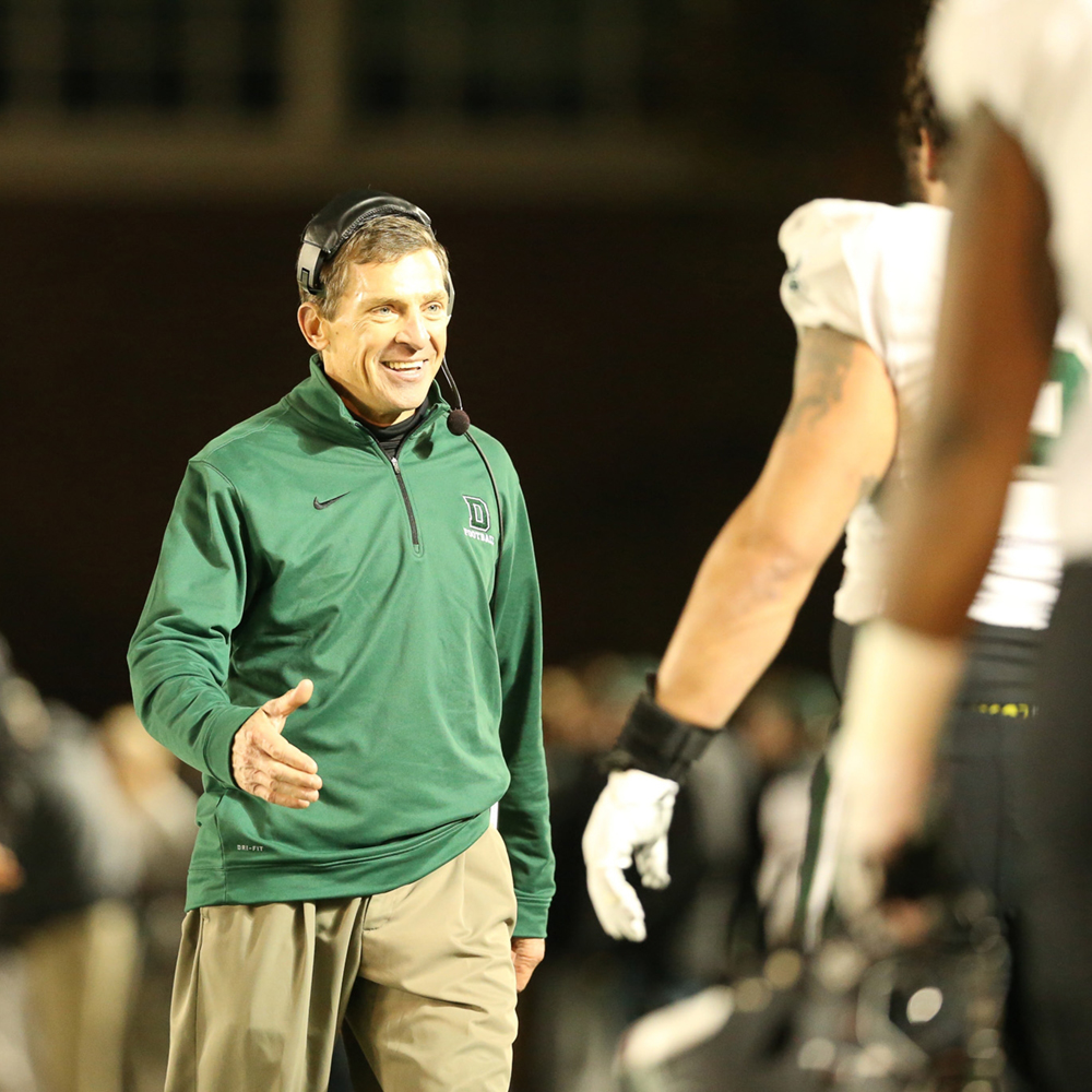 Buddy Teevens walks across the field ready to shake hands with his players at a Dartmouth football game